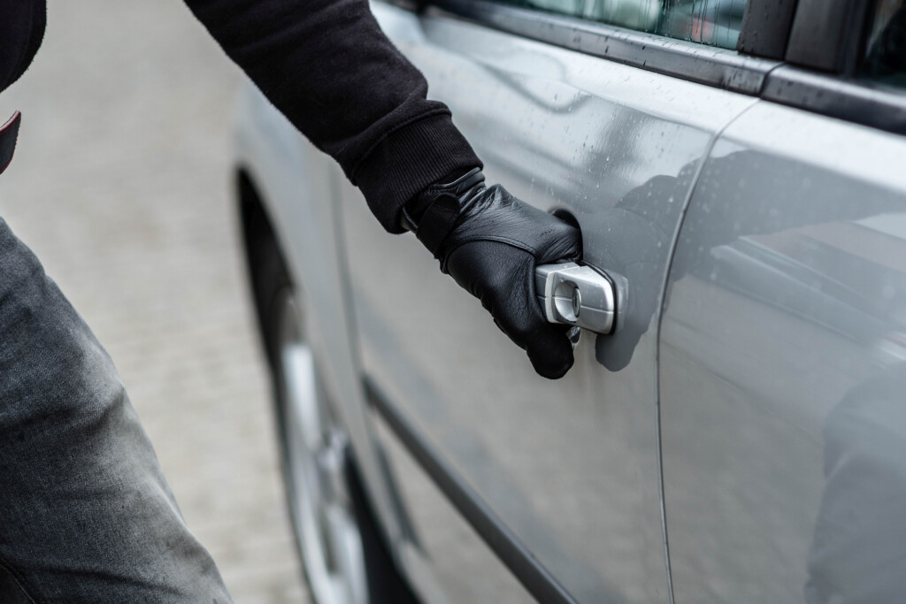 Car Thief Hand Pulling The Handle Of A Car