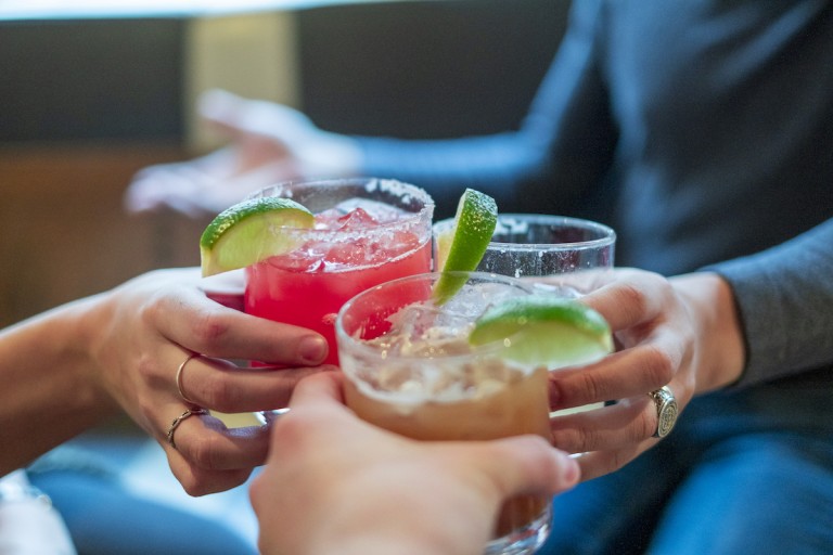 Friends Toasting With Margaritas And Tropical Drinks